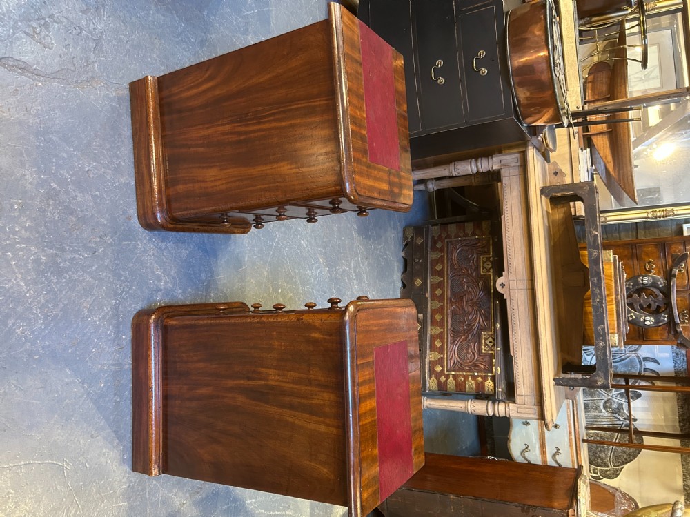 A pair of matching Victorian mahogany bedside chests of drawers featuring inset red leather tops and three drawers with turned wooden knobs. View XII