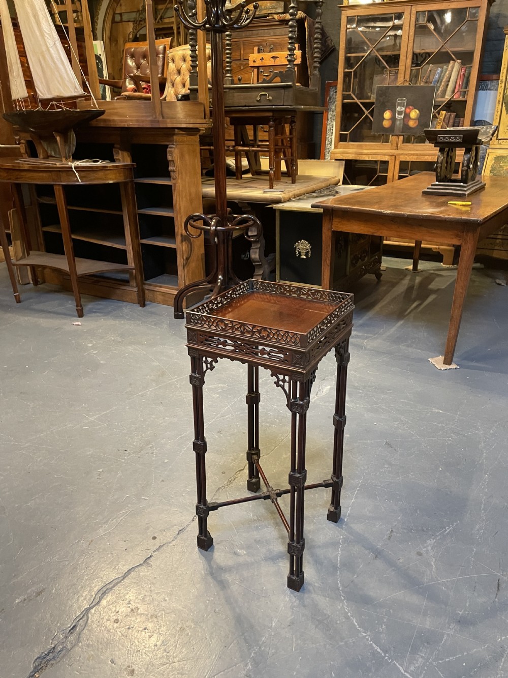 A tall mahogany Chippendale revival lamp table featuring a pierced fretwork gallery top, clustered column legs, and an X-form stretcher. View VIII