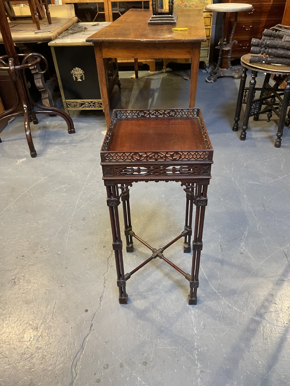 A tall mahogany Chippendale revival lamp table featuring a pierced fretwork gallery top, clustered column legs, and an X-form stretcher. View IX