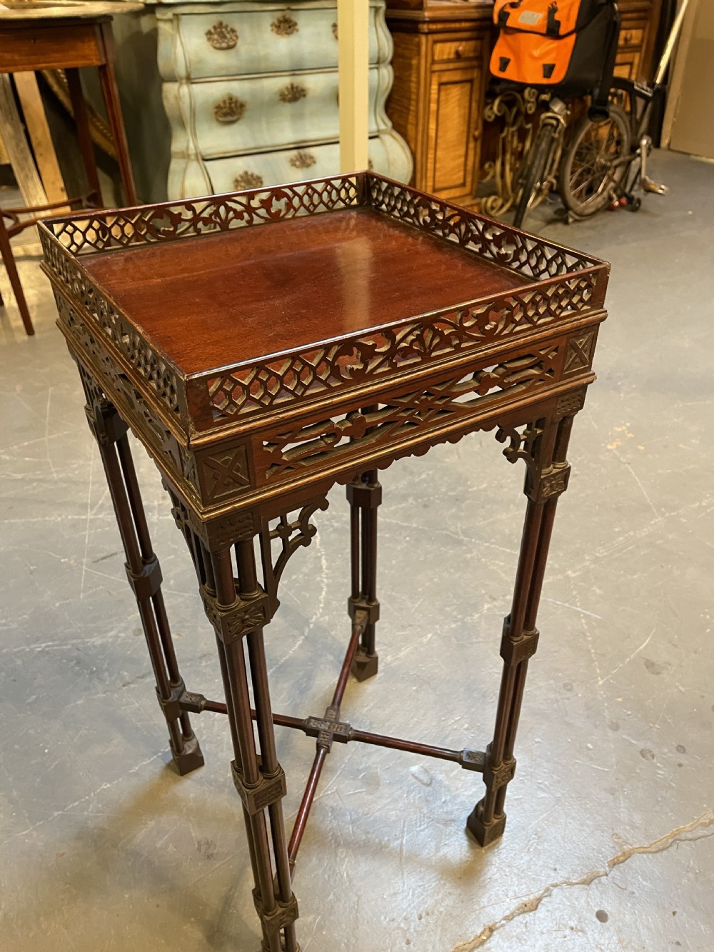A tall mahogany Chippendale revival lamp table featuring a pierced fretwork gallery top, clustered column legs, and an X-form stretcher. View X