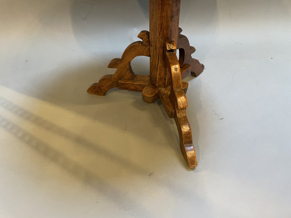 An 18th-century rustic pine pedestal table featuring a round plank top and carved tripod legs with a warm timber patina. View XI