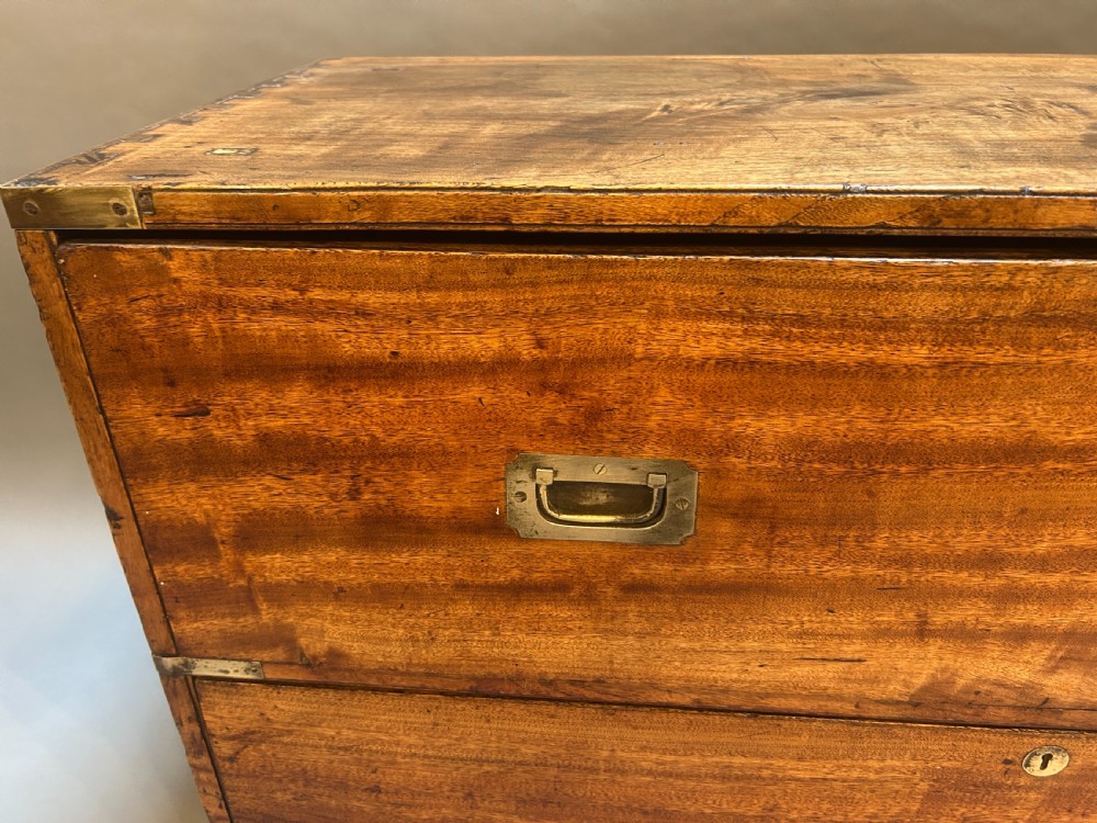 A nineteenth-century mahogany campaign chest featuring two wide drawers with flush brass handles, protective brass corner mounts, and side carrying handles. View VIII