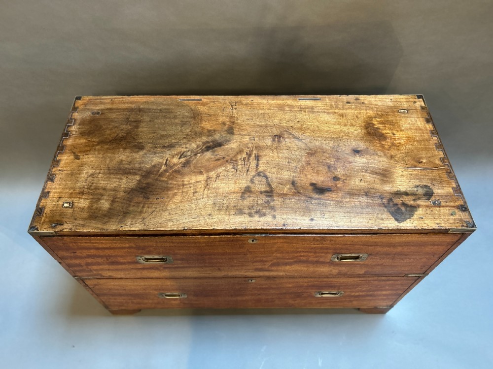 A nineteenth-century mahogany campaign chest featuring two wide drawers with flush brass handles, protective brass corner mounts, and side carrying handles. View IX