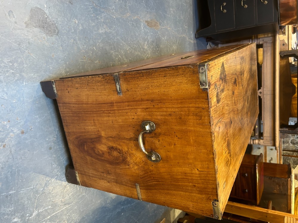 A nineteenth-century mahogany campaign chest featuring two wide drawers with flush brass handles, protective brass corner mounts, and side carrying handles. View X