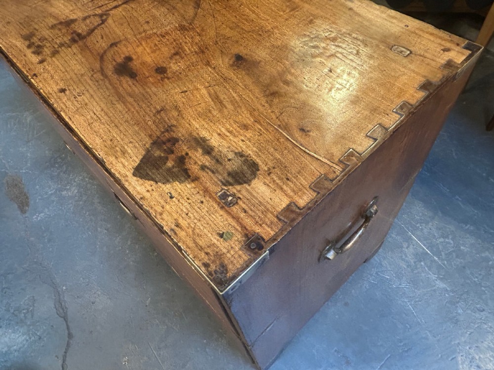A nineteenth-century mahogany campaign chest featuring two wide drawers with flush brass handles, protective brass corner mounts, and side carrying handles. View XI