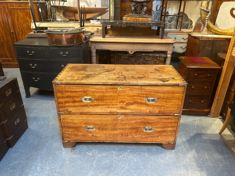A nineteenth-century mahogany campaign chest featuring two wide drawers with flush brass handles, protective brass corner mounts, and side carrying handles. View XIV