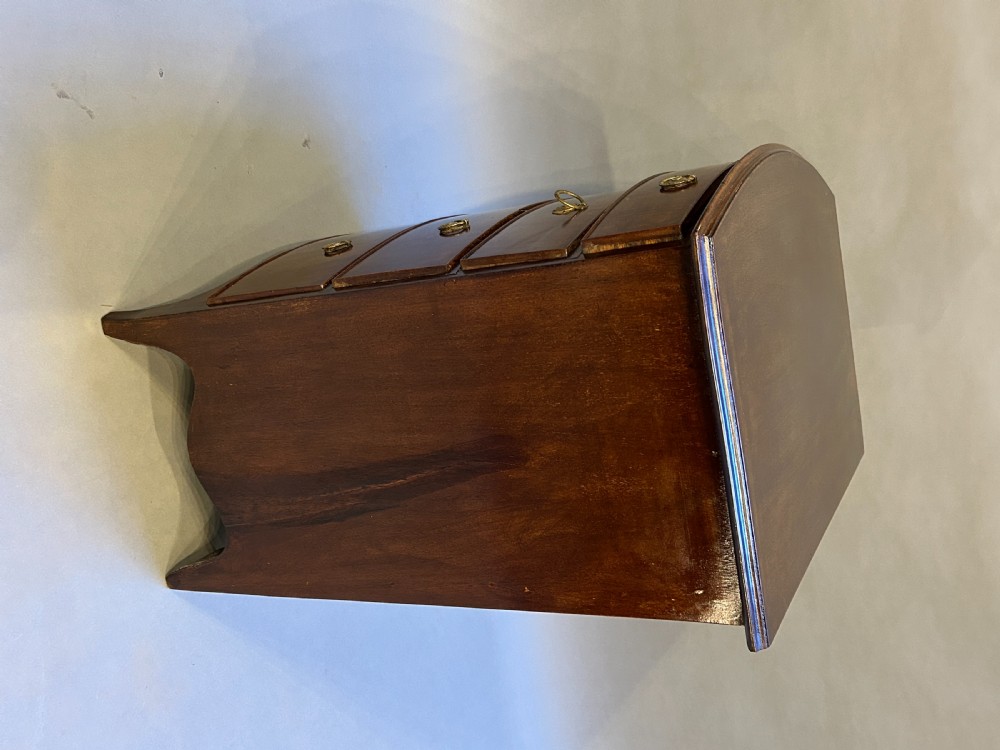 An Edwardian mahogany bow-front chest of drawers with four graduated drawers, circular brass handles, and splayed bracket feet. View VI