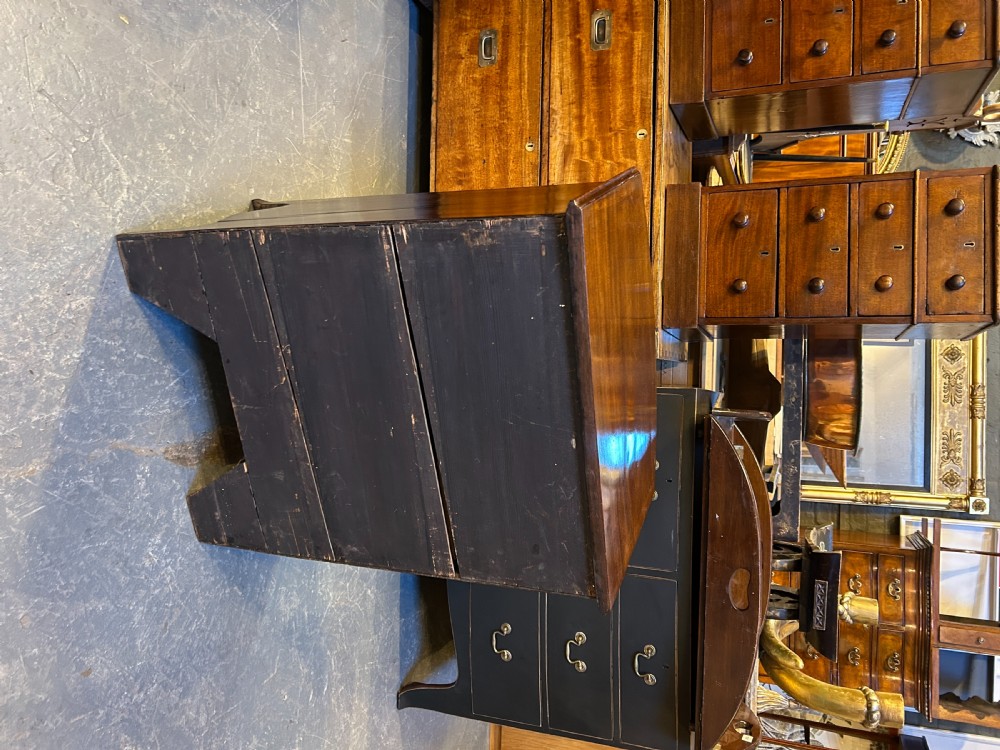An Edwardian mahogany bow-front chest of drawers with four graduated drawers, circular brass handles, and splayed bracket feet. View IX