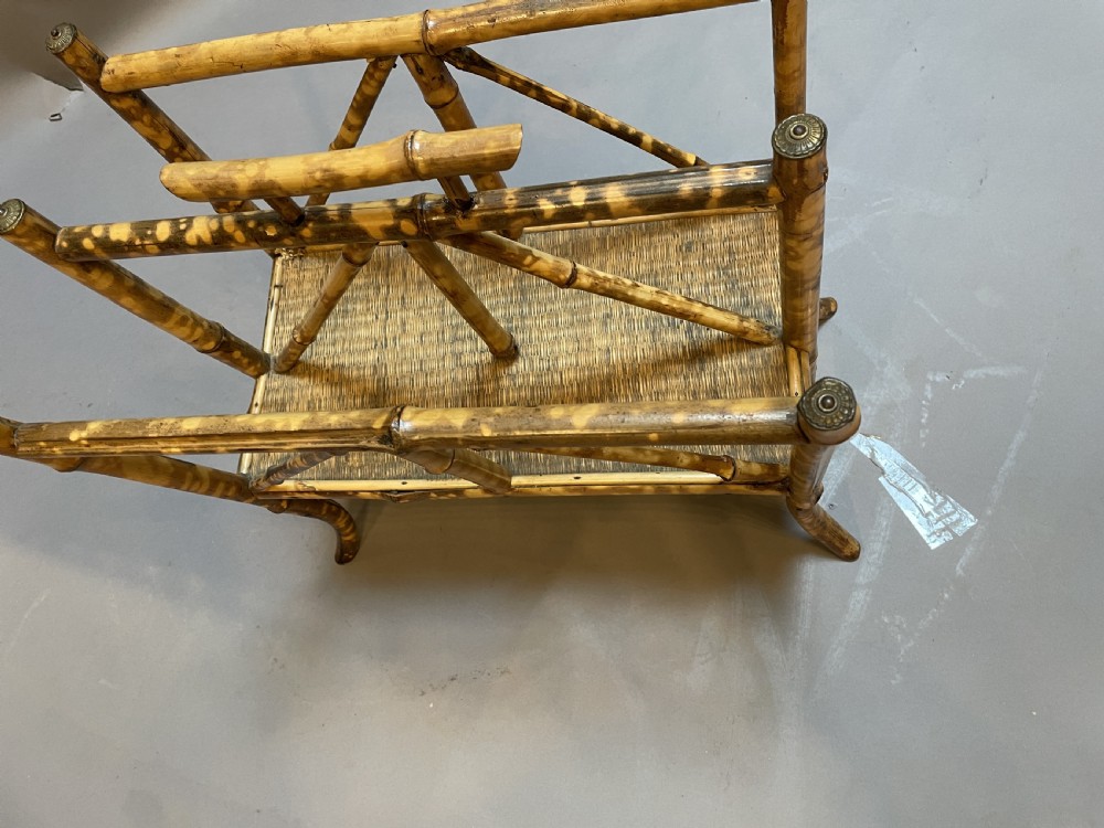 A late 19th-century bamboo canterbury rack featuring diagonal cross-bracing, a woven lower shelf, four partitioned sections, and metal capped finials. View III