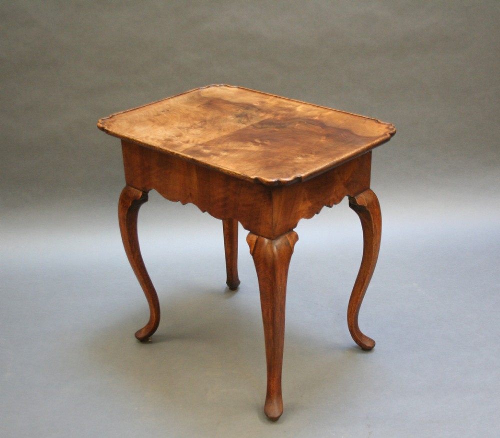 A George III style walnut lowboy side table featuring a single central drawer, shaped apron, and cabriole legs. View V