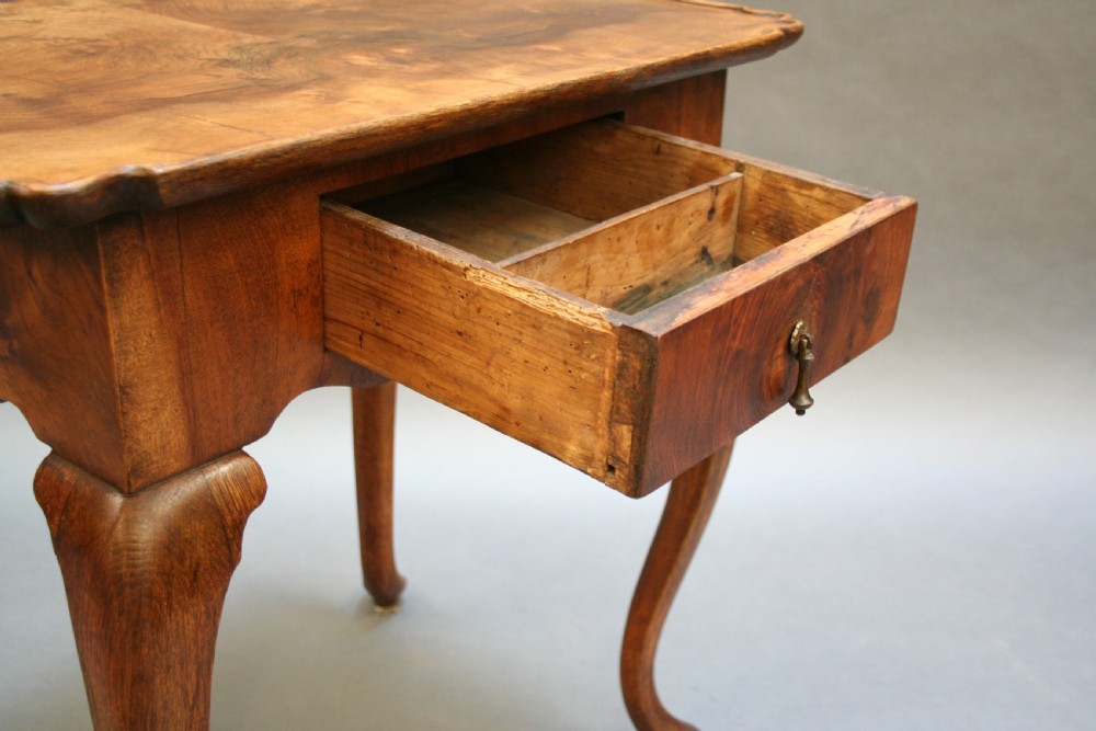 A George III style walnut lowboy side table featuring a single central drawer, shaped apron, and cabriole legs. View VIII