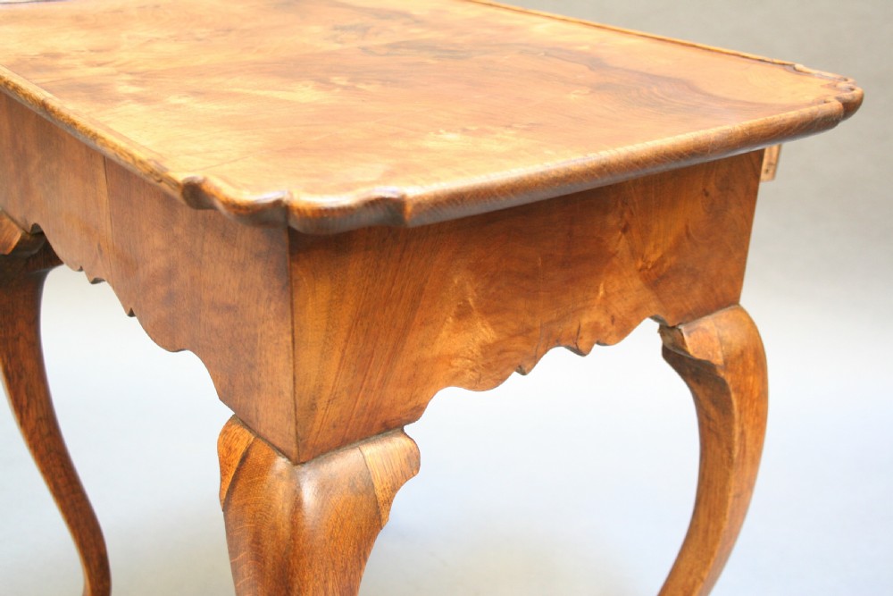 A George III style walnut lowboy side table featuring a single central drawer, shaped apron, and cabriole legs. View IX