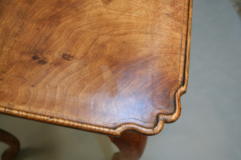 A George III style walnut lowboy side table featuring a single central drawer, shaped apron, and cabriole legs. View XI