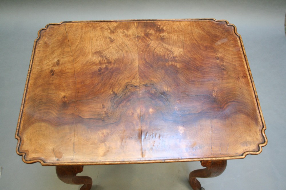 A George III style walnut lowboy side table featuring a single central drawer, shaped apron, and cabriole legs. View XIII