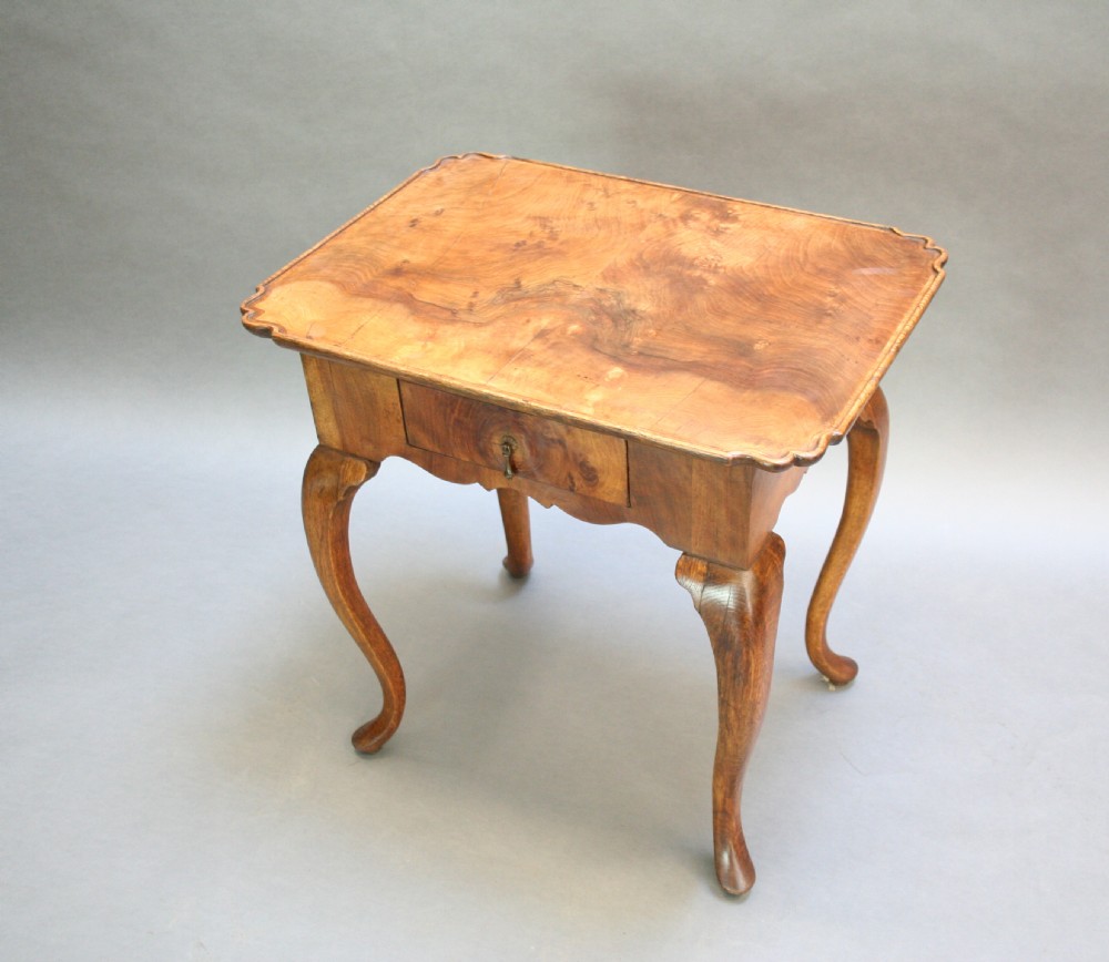 A George III style walnut lowboy side table featuring a single central drawer, shaped apron, and cabriole legs. View XIV