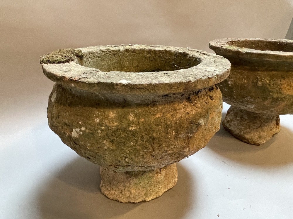 A pair of nineteenth-century carved soft stone garden urns featuring a rounded basin on a short pedestal base with a weathered, textured surface. View III
