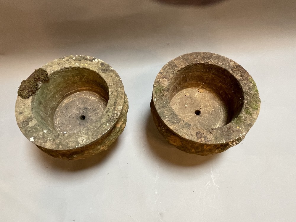A pair of nineteenth-century carved soft stone garden urns featuring a rounded basin on a short pedestal base with a weathered, textured surface. View IV