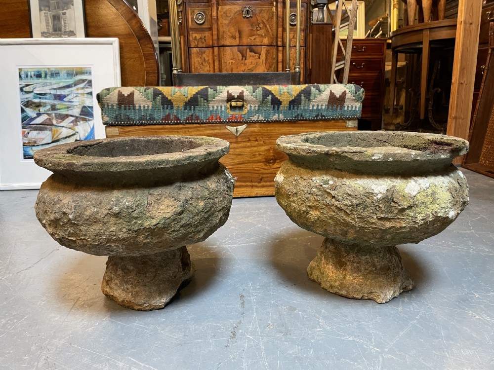A pair of nineteenth-century carved soft stone garden urns featuring a rounded basin on a short pedestal base with a weathered, textured surface. View VIII