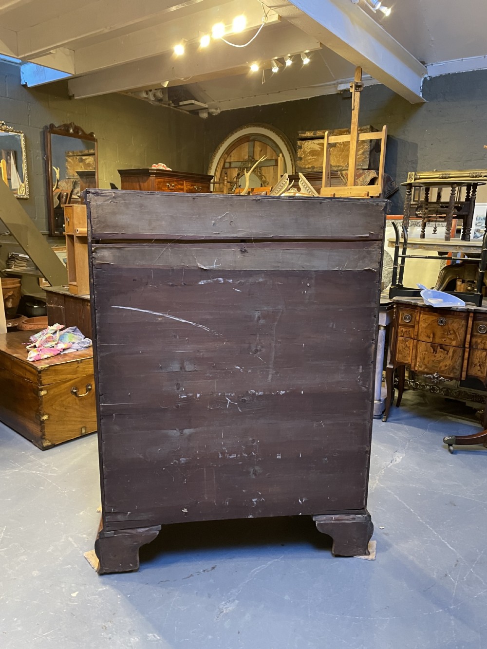 A George III mahogany tall chest of drawers featuring two short over five long graduated drawers with brass swan-neck handles and bracket feet. View XI