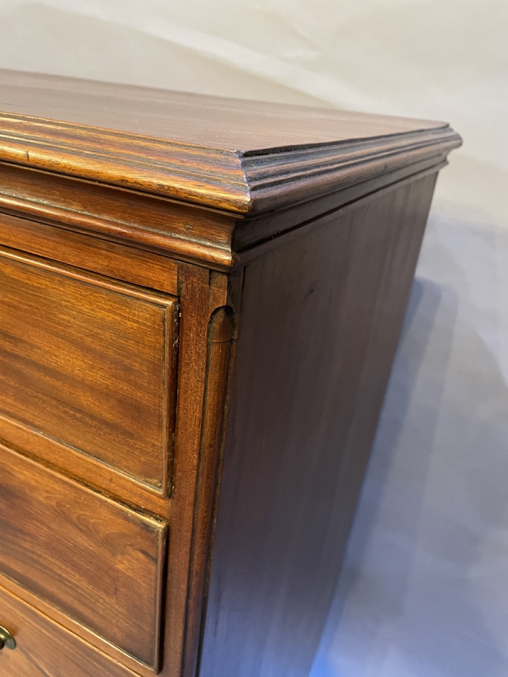 A George III mahogany tall chest of drawers featuring two short over five long graduated drawers with brass swan-neck handles and bracket feet. View XVII