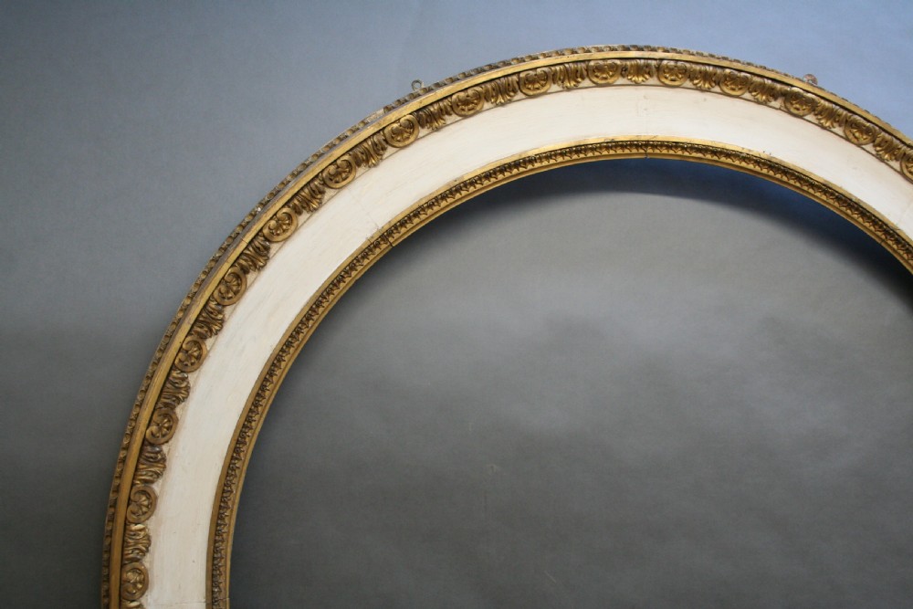 A large nineteenth-century arched pier mirror featuring a gilt and cream frame adorned with egg-and-dart moulding. View VII