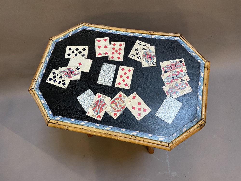 A late nineteenth-century Victorian bamboo occasional table featuring a two-tier structure with decoupage playing cards under varnish on the surfaces. View II