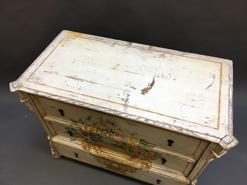 A 19th-century cream painted chest of drawers featuring three long drawers decorated with a central hand-painted motif of a floral urn. View III