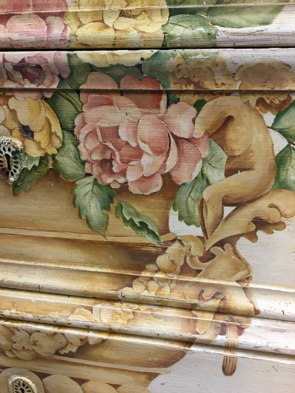 A 19th-century cream painted chest of drawers featuring three long drawers decorated with a central hand-painted motif of a floral urn. View VII
