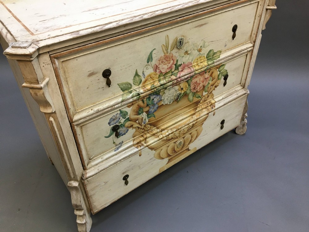 A 19th-century cream painted chest of drawers featuring three long drawers decorated with a central hand-painted motif of a floral urn. View IX