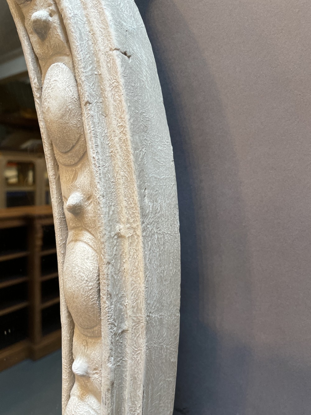 A 19th-century arched overmantel mirror featuring an off-white painted frame decorated with beaded moulding and small projecting feet. View X