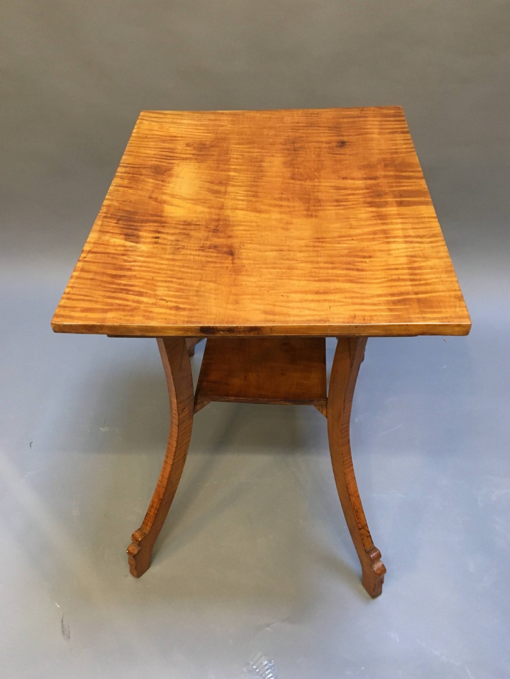 An Art Deco golden Karelian birch side table featuring a square top, lower tier shelf, and flared outward curved legs. View VI