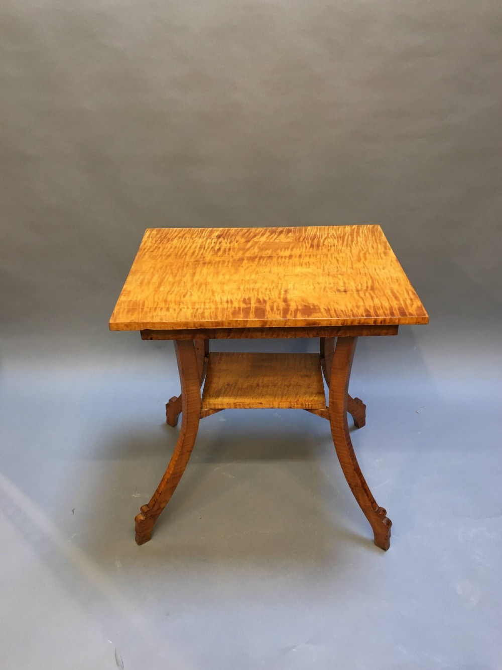 An Art Deco golden Karelian birch side table featuring a square top, lower tier shelf, and flared outward curved legs. View VIII