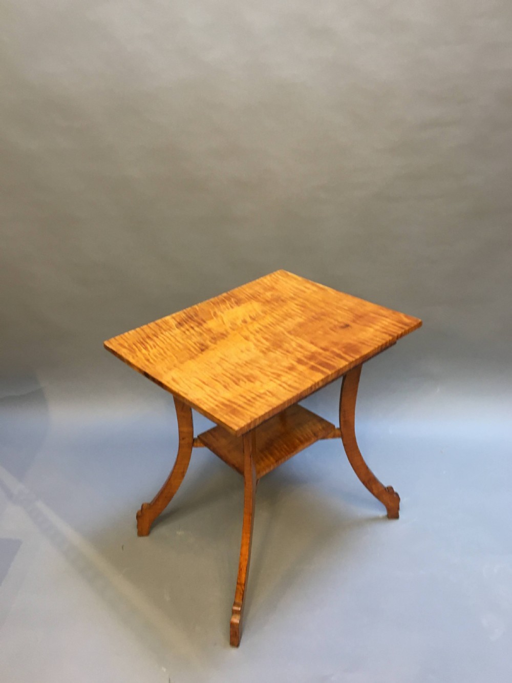 An Art Deco golden Karelian birch side table featuring a square top, lower tier shelf, and flared outward curved legs. View XI