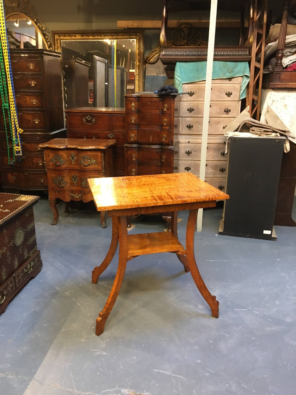 An Art Deco golden Karelian birch side table featuring a square top, lower tier shelf, and flared outward curved legs. View XII
