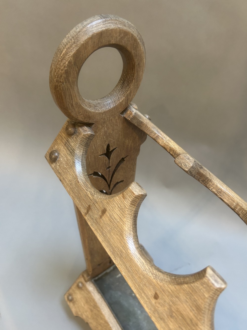 An antique oak umbrella and stick stand featuring a scalloped upper rail, carved ring handles, inlaid side uprights, and a metal drip tray at the base. View IV