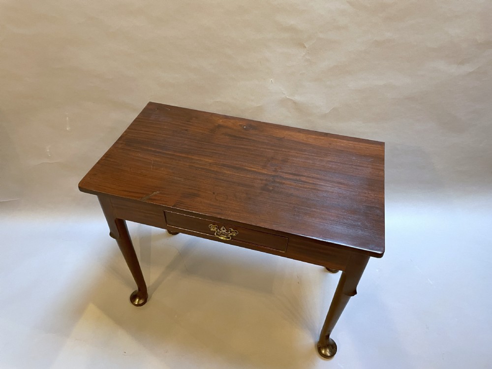 A George III mahogany side table featuring a single drawer with a brass handle and cabriole legs terminating in pad feet. View II