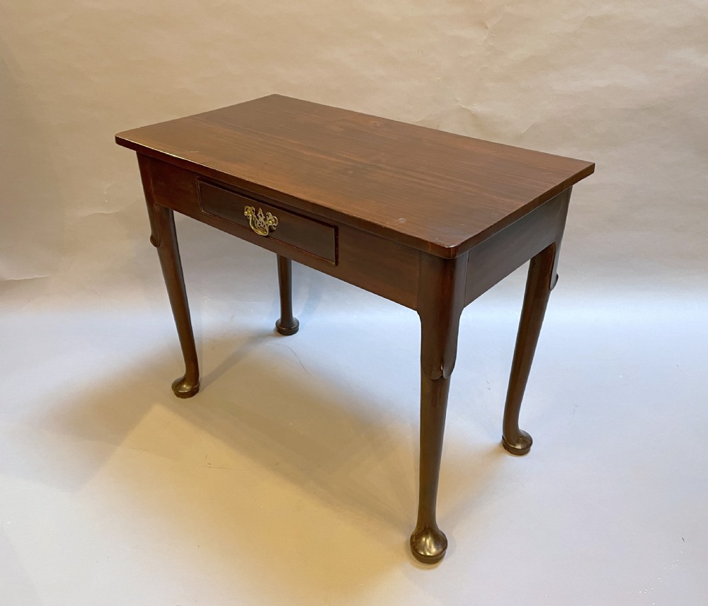 A George III mahogany side table featuring a single drawer with a brass handle and cabriole legs terminating in pad feet. View III