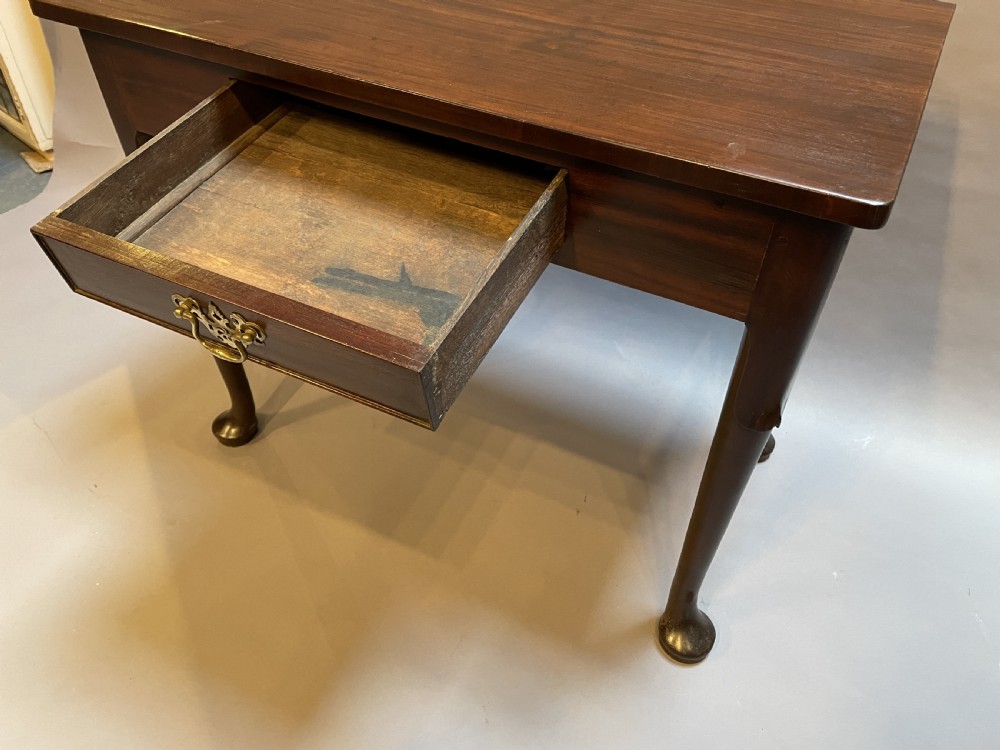A George III mahogany side table featuring a single drawer with a brass handle and cabriole legs terminating in pad feet. View V