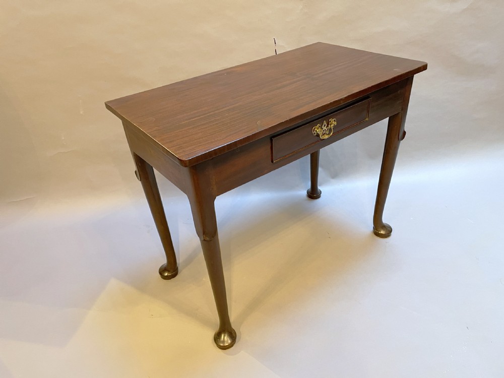 A George III mahogany side table featuring a single drawer with a brass handle and cabriole legs terminating in pad feet. View VI
