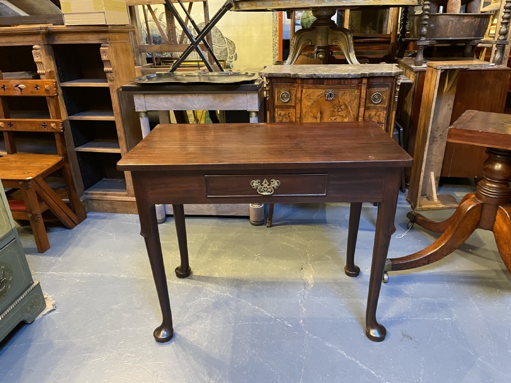 A George III mahogany side table featuring a single drawer with a brass handle and cabriole legs terminating in pad feet. View VIII