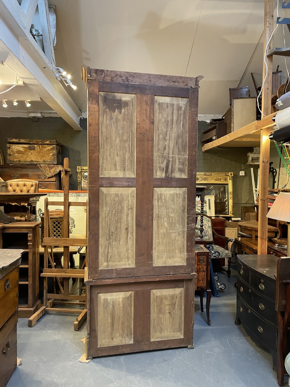 A tall Victorian light oak two-part bookcase with two upper glazed doors revealing adjustable shelves and a two-door cupboard base. View VII