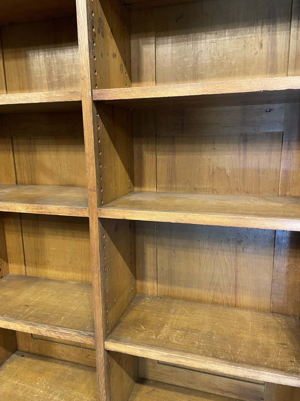 A tall Victorian light oak two-part bookcase with two upper glazed doors revealing adjustable shelves and a two-door cupboard base. View XV