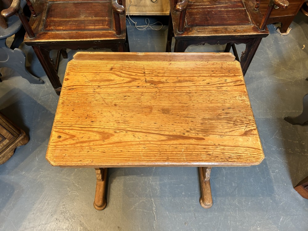 An early twentieth-century pine lectern table featuring a slanted reading surface with a retaining lip, supported by a trestle base with a lower shelf. View VII