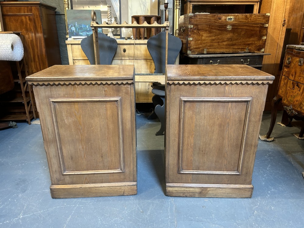 A pair of light oak four-drawer bedside chests featuring carved top edge details and brass drop handles. View II