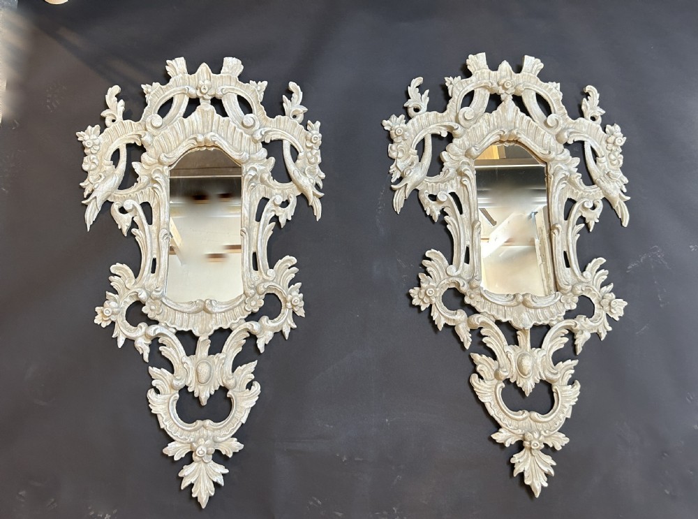 A 19th-century Continental wall mirror with an ornate carved off-white frame featuring intricate scrollwork, acanthus leaves, and shell motifs. View IV