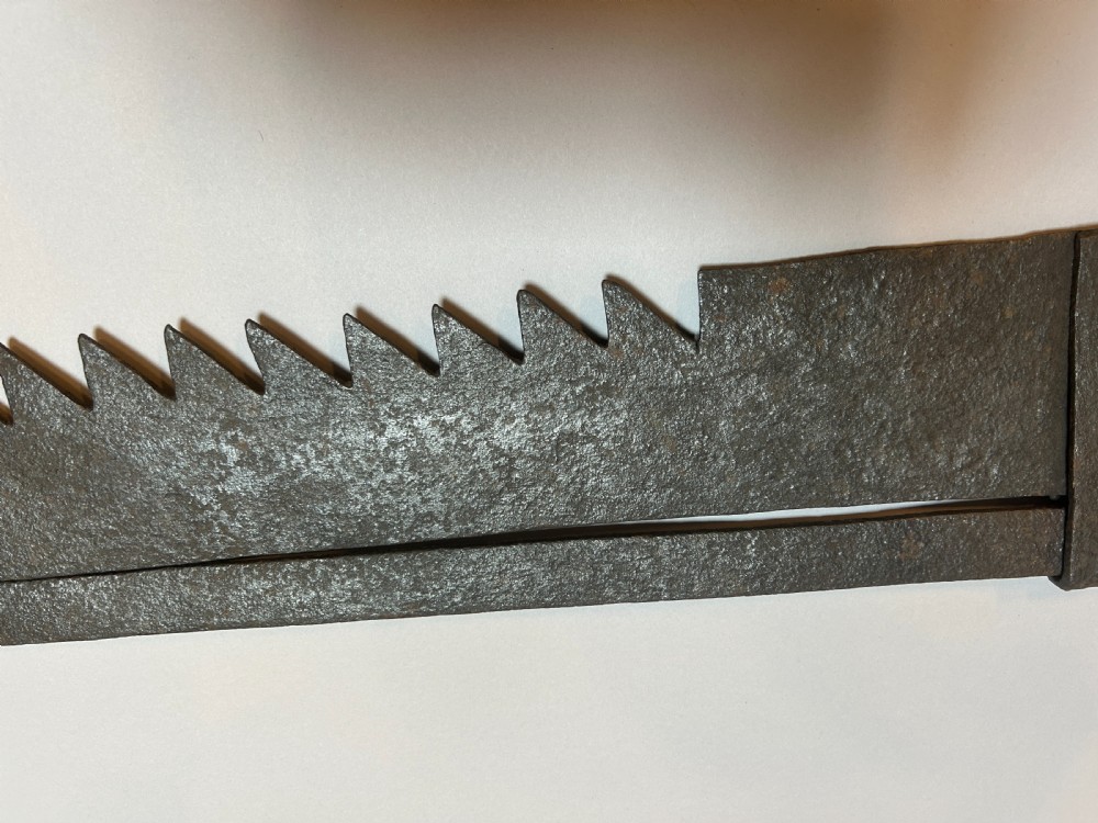 An 18th-century hand-forged wrought iron adjustable chimney crane featuring a sawtooth trammel mechanism, scrolled ends, and a decorative rosette. View III