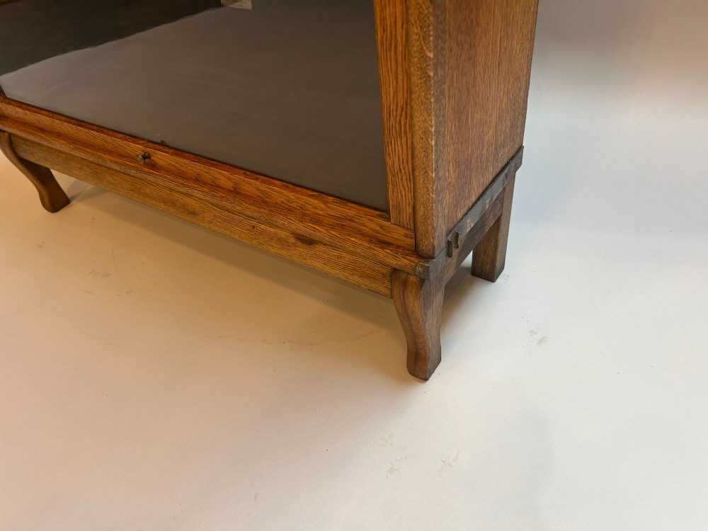 A four-tier oak Globe Wernicke stacking barrister bookcase with glazed up-and-over doors. View III