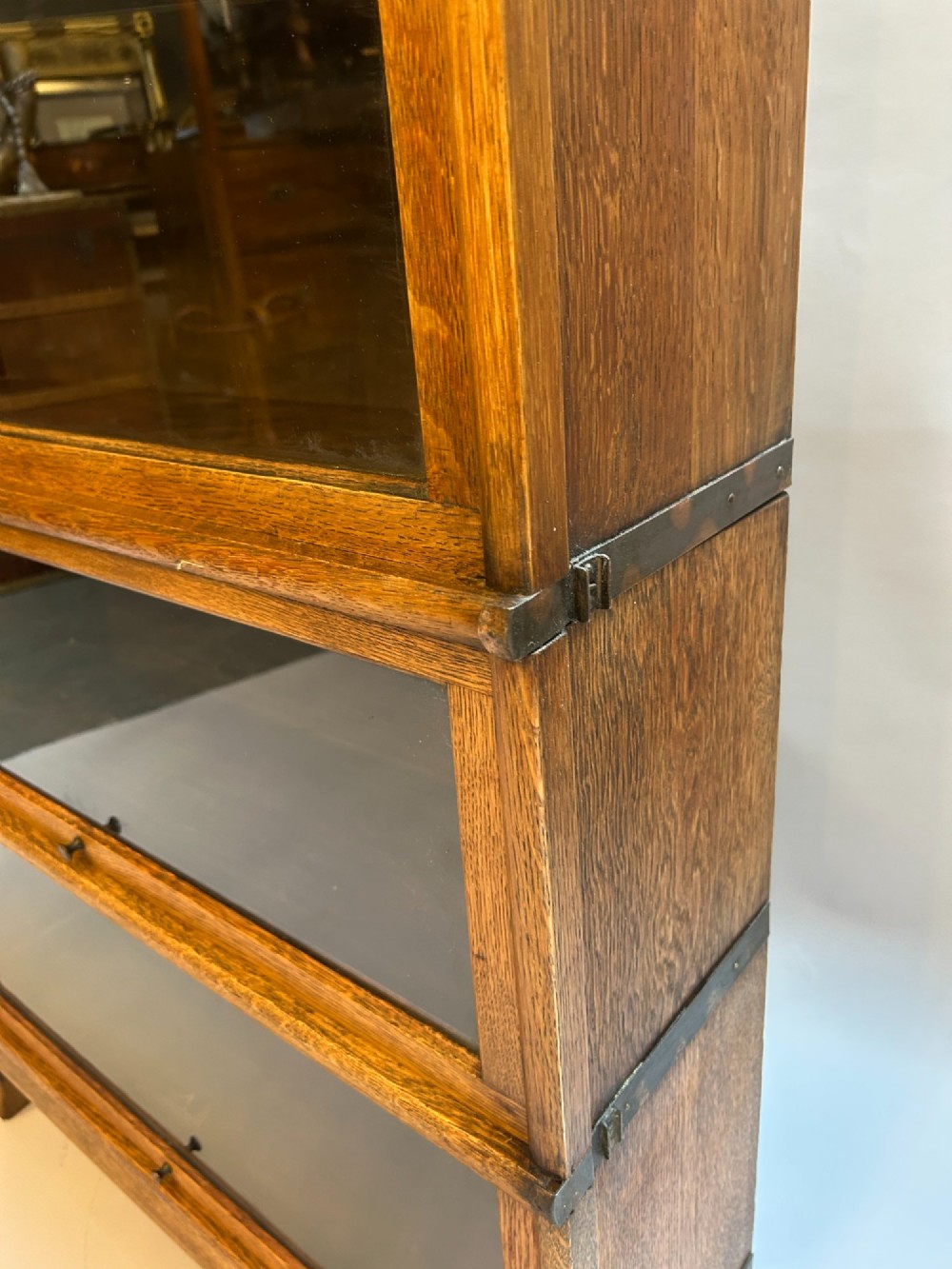 A four-tier oak Globe Wernicke stacking barrister bookcase with glazed up-and-over doors. View IV