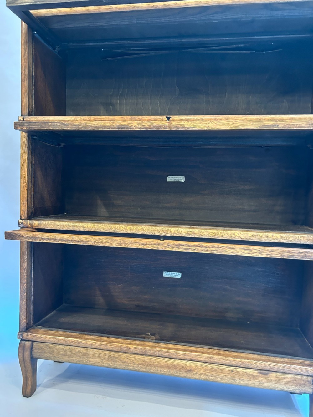 A four-tier oak Globe Wernicke stacking barrister bookcase with glazed up-and-over doors. View VI
