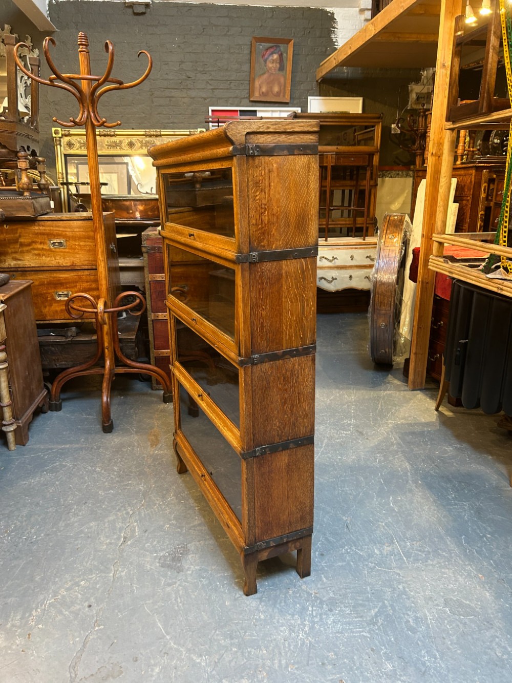 A four-tier oak Globe Wernicke stacking barrister bookcase with glazed up-and-over doors. View VIII